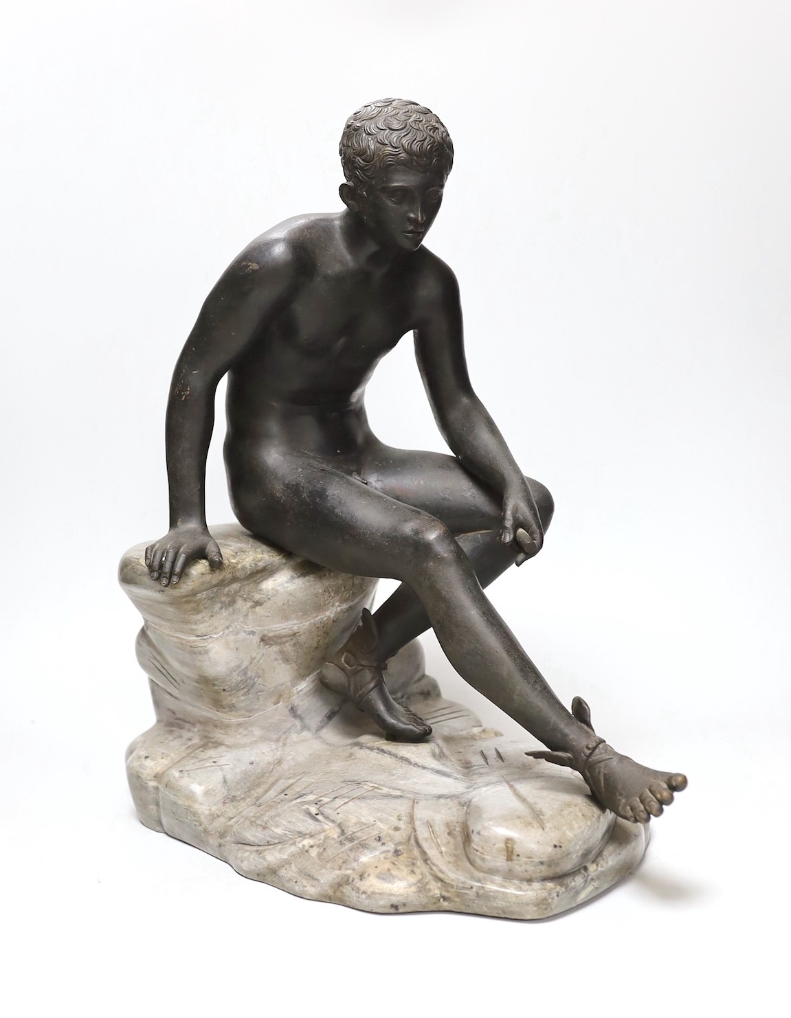 After the Antique, a late 19th century bronze figure of Mercury, seated on a grey marble naturalistic rocky base, 41cm high